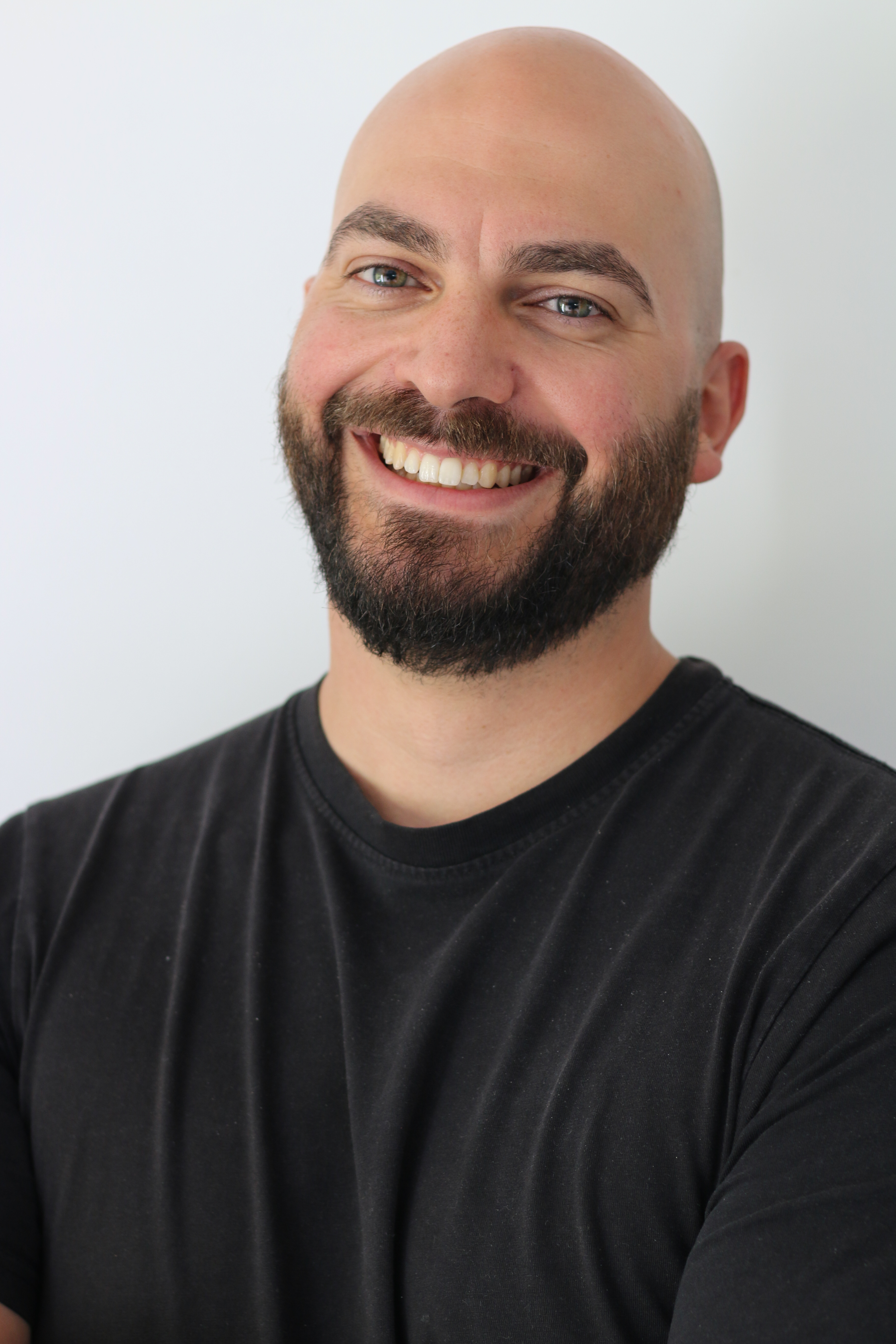 Dennis Demmer smiling in a black shirt